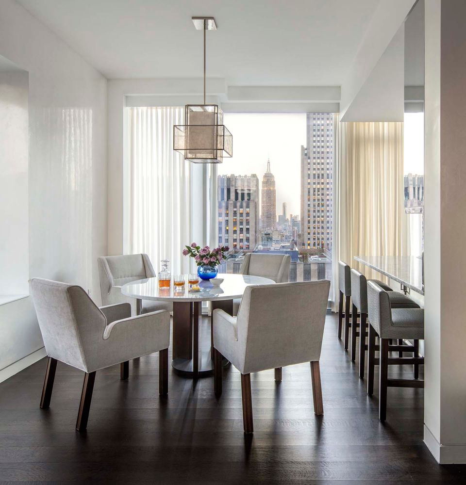 20 West 53rd Street, Unit 42A Manhattan, NY 10019 - Photo 6 of 31 a view of a dining room with furniture window and wooden floor