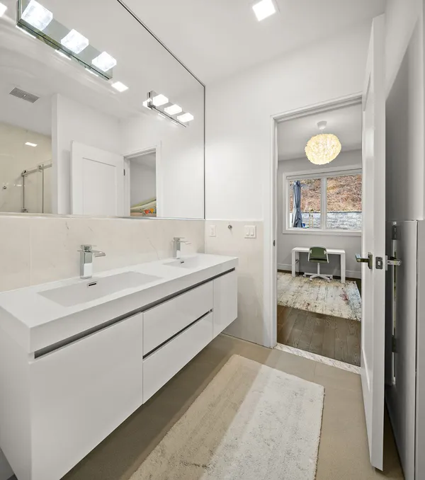 a bathroom with a double vanity sink and a mirror