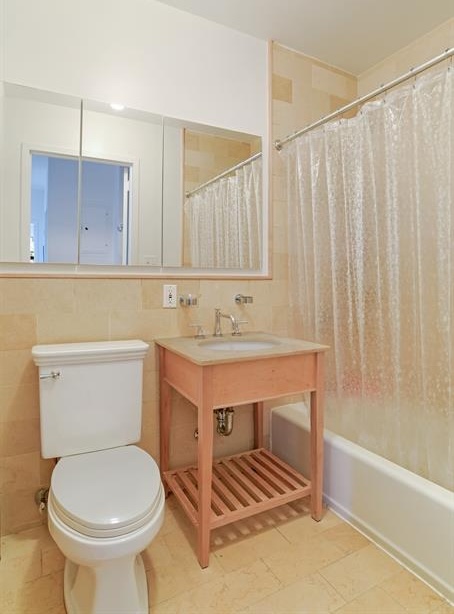 60 Tiffany Place, Unit 1A Brooklyn, NY 11231 - Photo 4 of 11 a bathroom with a sink a toilet and a bathtub