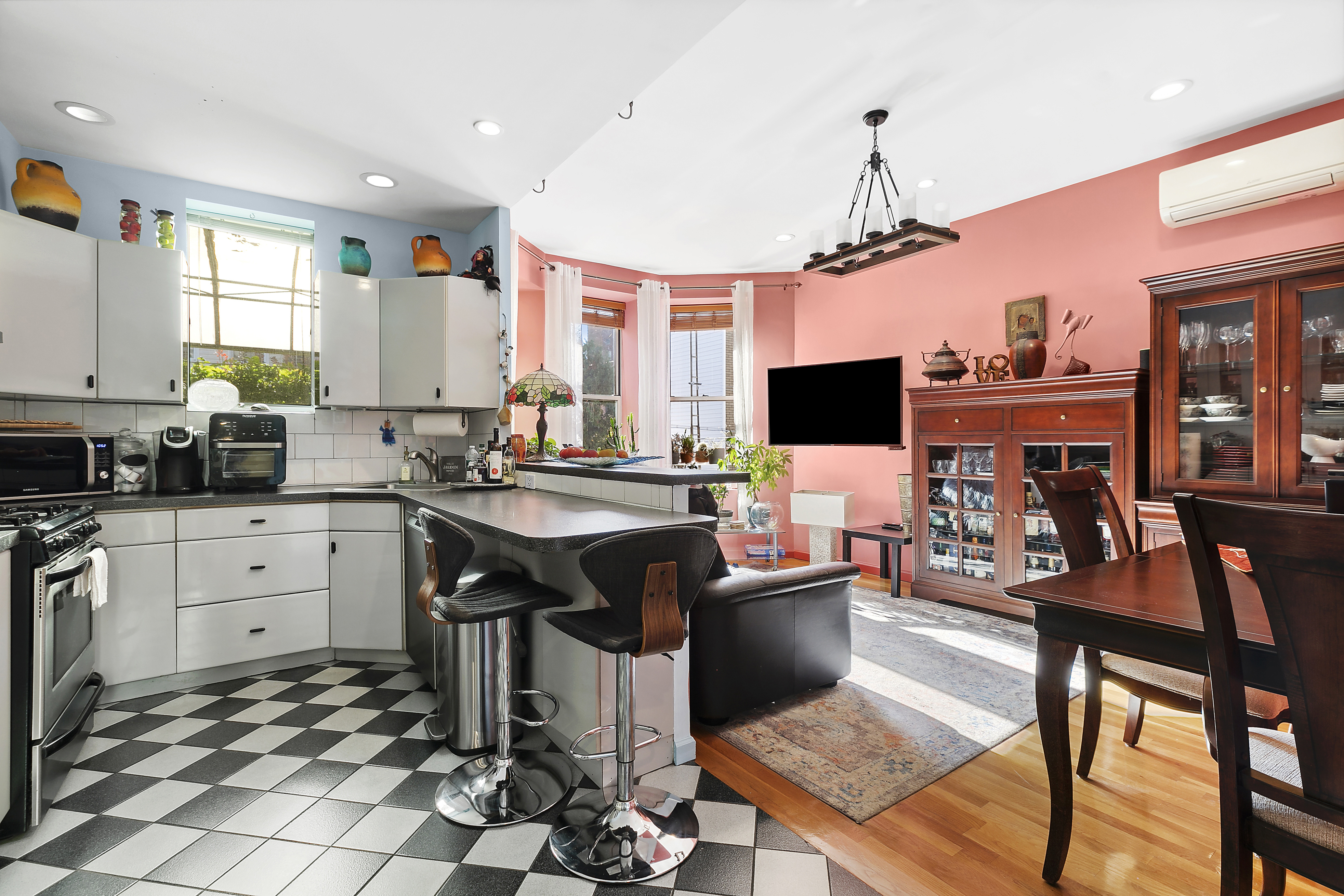 60-38 68th Road Queens, NY 11385 - Photo 2 of 14 a open kitchen with stainless steel appliances granite countertop a stove and a view of living room