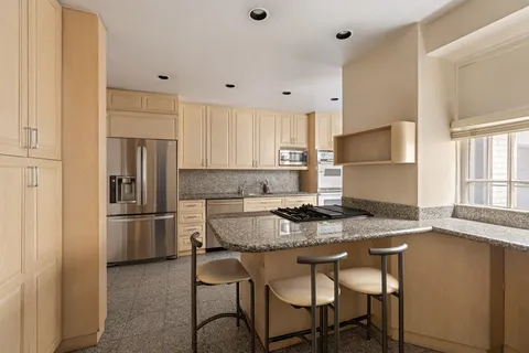 a kitchen with a stove a refrigerator and island