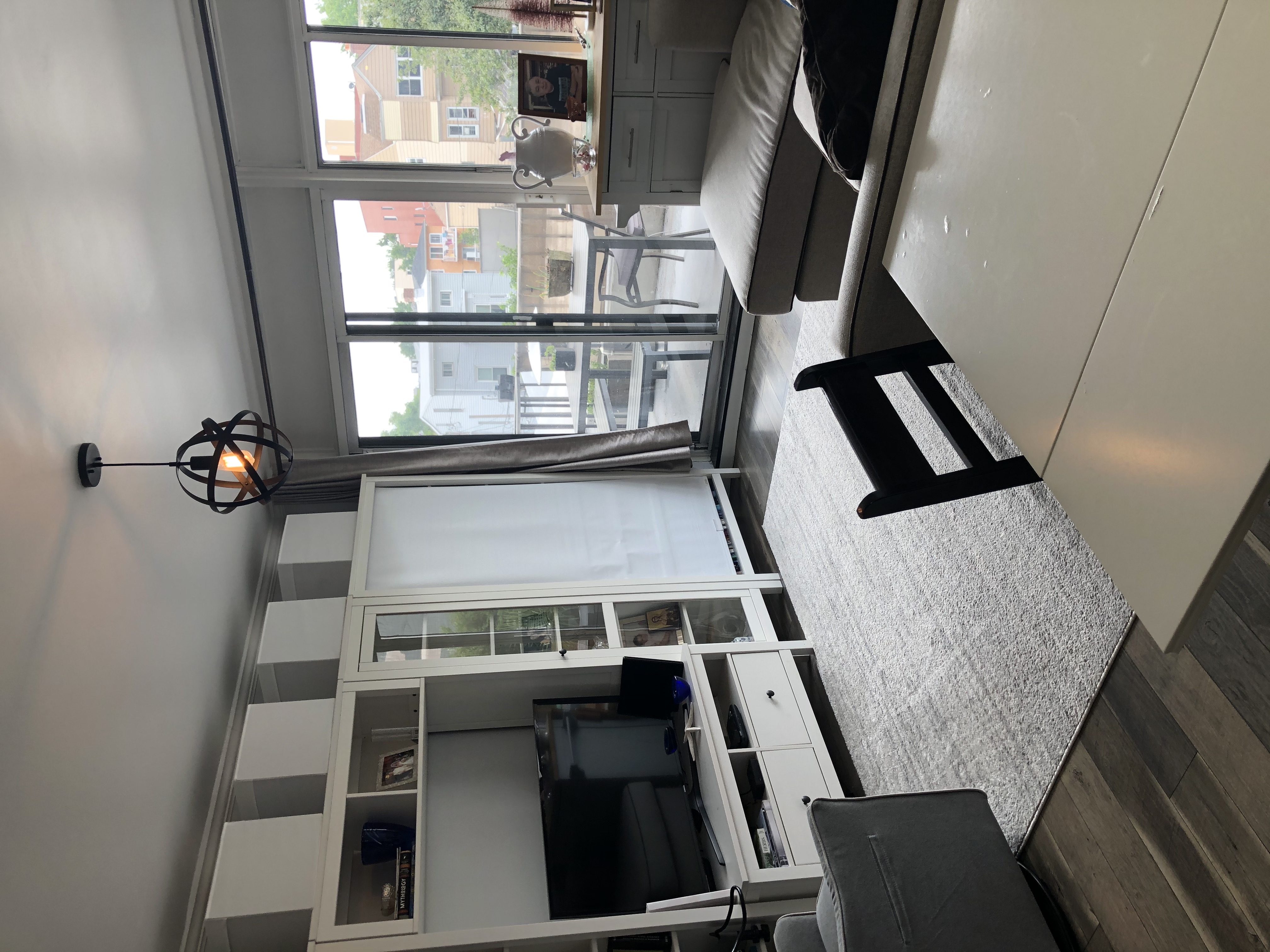 25-40 Shore Boulevard, Unit 2F Queens, NY 11102 - Photo 5 of 31 a living room with furniture a flat screen tv and floor to ceiling window