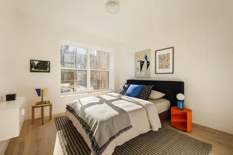 a bedroom with bed and a window