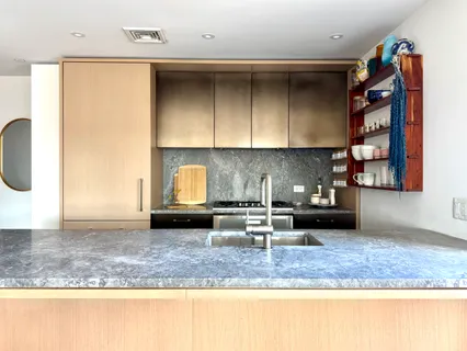 a kitchen with a sink a counter and cabinets