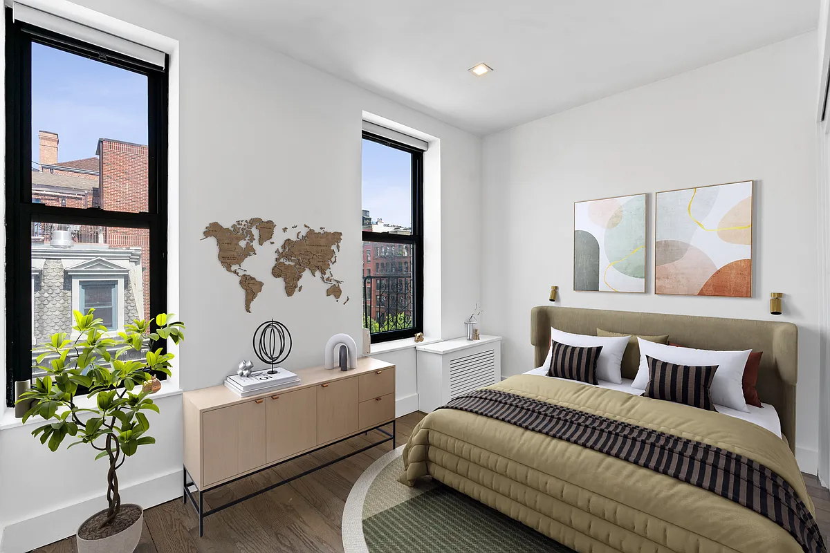 152 Thompson Street, Unit 5E Manhattan, NY 10012 - Photo 5 of 10 a living room with furniture and a potted plant