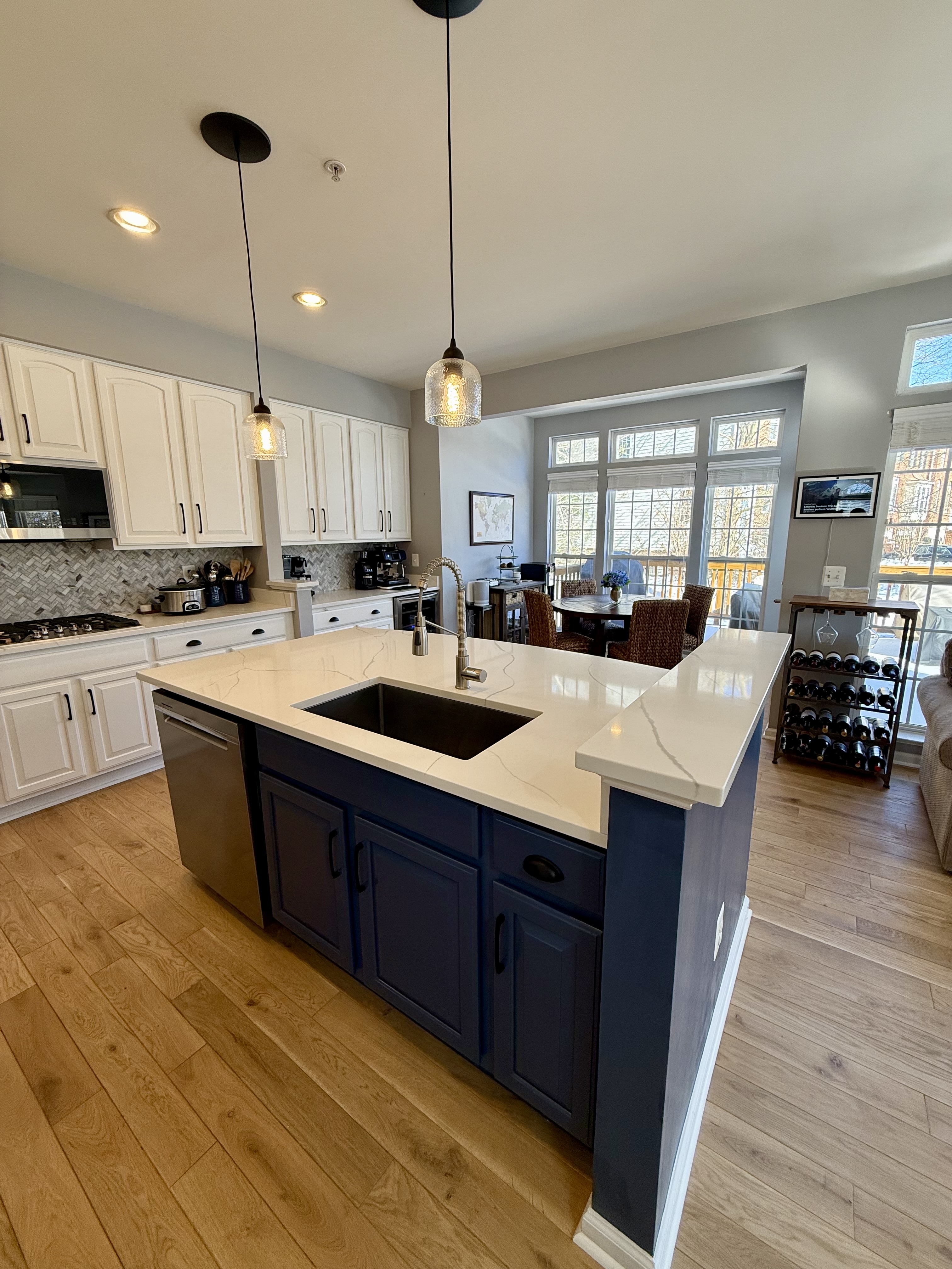 Address Upon Request Leesburg, VA 20176 - Photo 20 of 55 a large kitchen with kitchen island a stove a sink a center island and wooden floor
