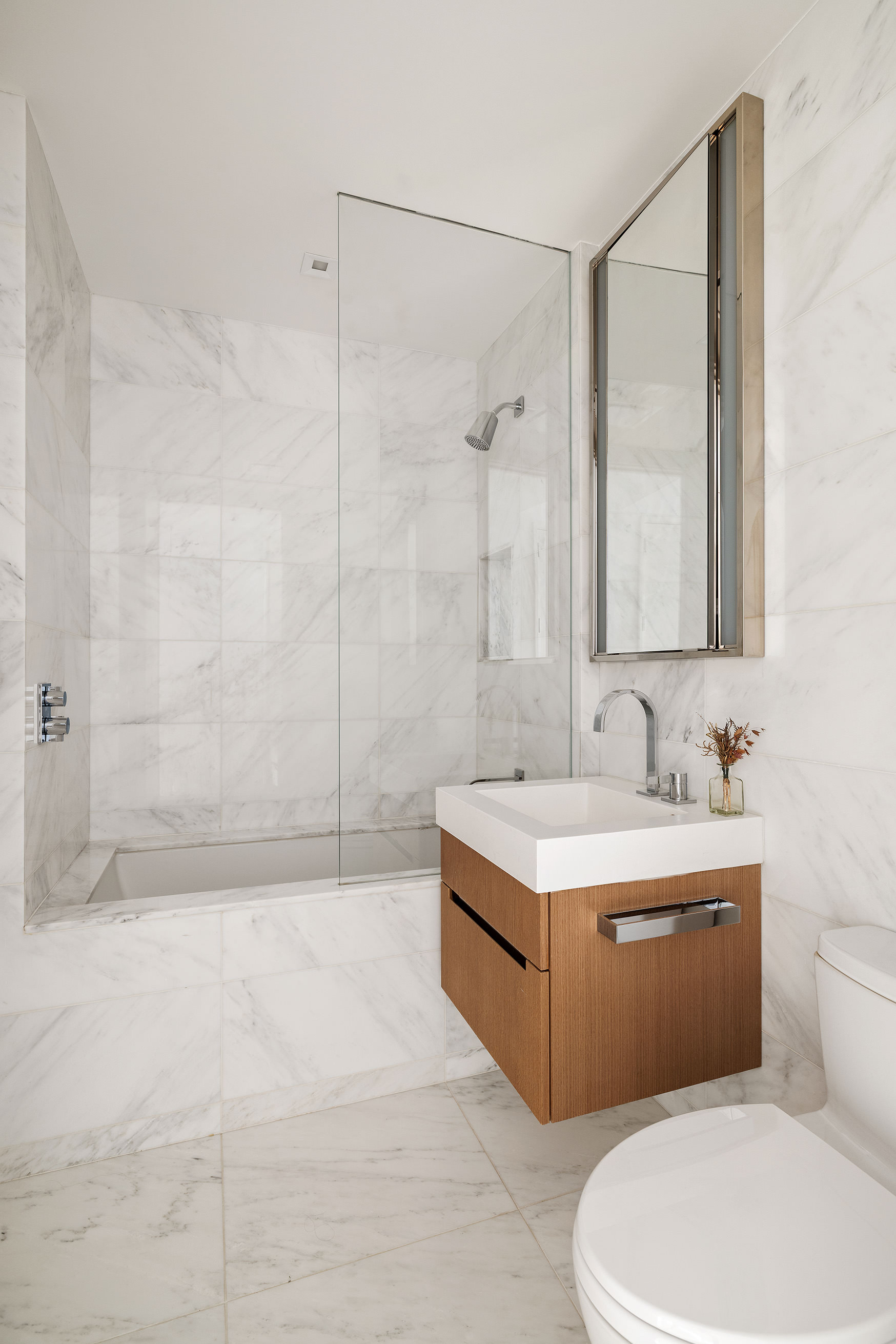 1 West End Avenue, Unit 25F Manhattan, NY 10023 - Photo 11 of 15 a bathroom with a sink toilet and shower