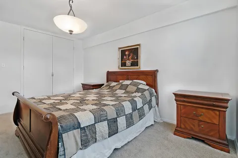 a bedroom with a bed and cabinet