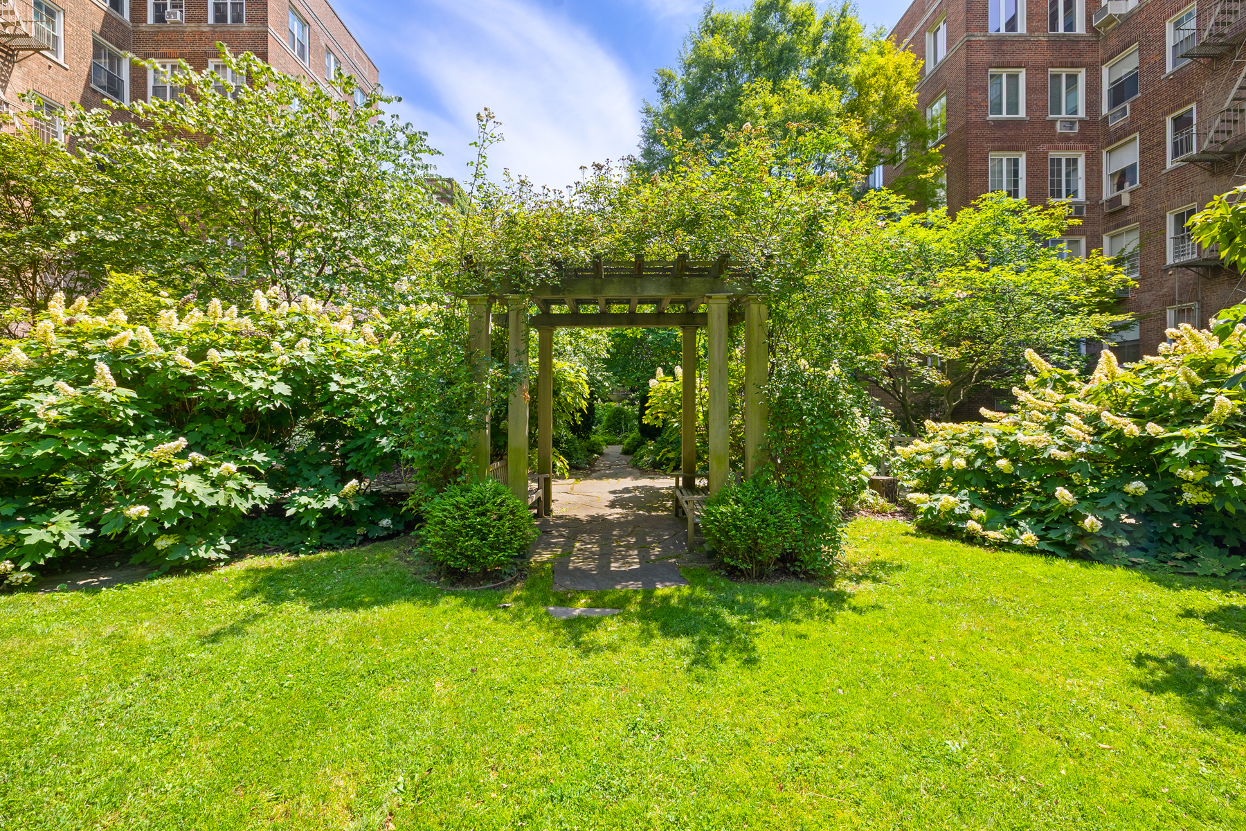 35-27 76th Street, Unit 21 Queens, NY 11372 - Photo 23 of 24 a view of a garden with a building