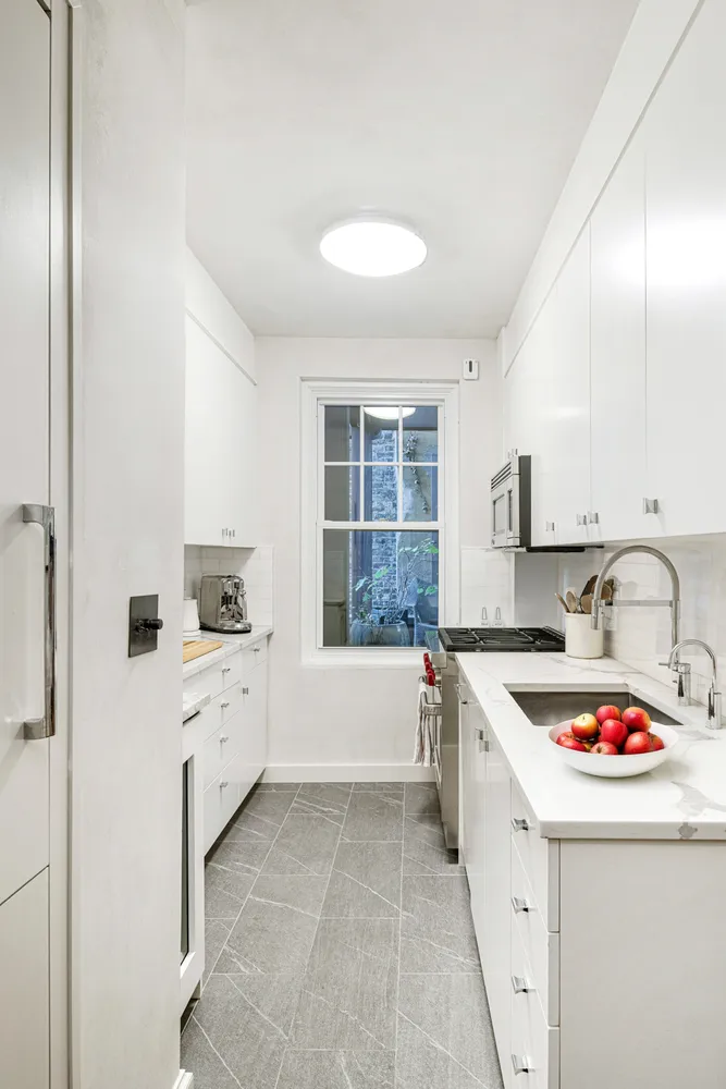 a kitchen that has a sink and a stove in it