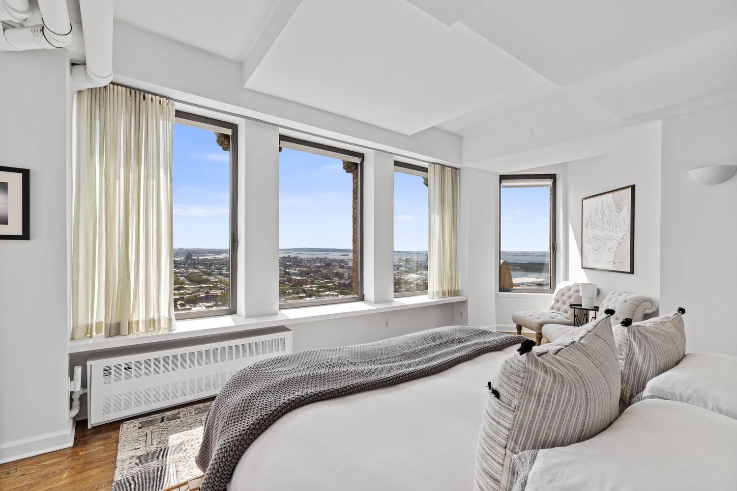 a bed sitting in a bedroom next to a window