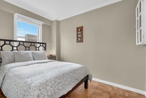 a bedroom with a bed and a window