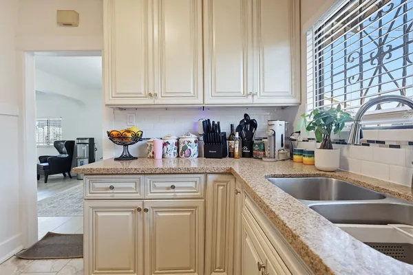 a kitchen with stainless steel appliances granite countertop a sink and cabinets