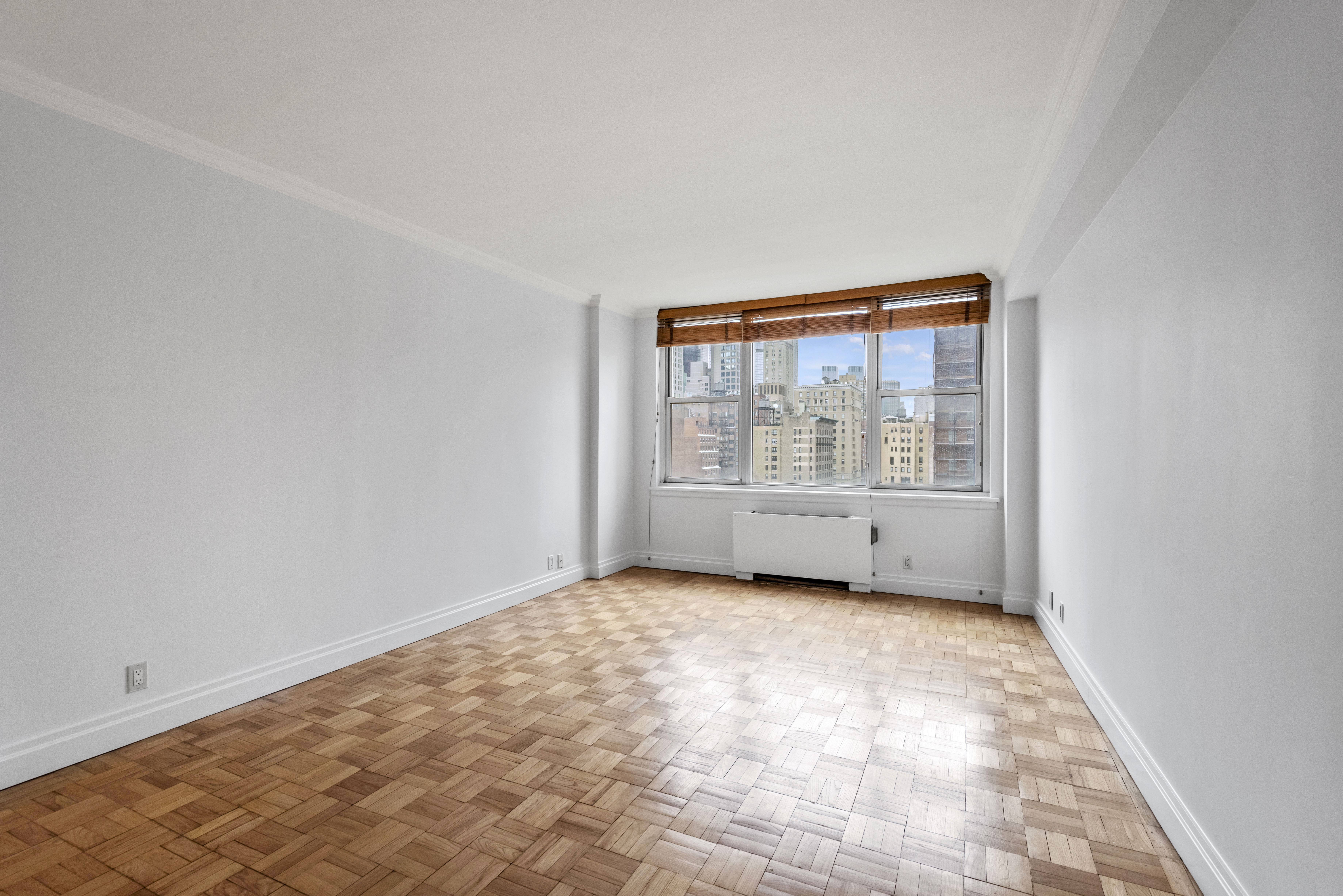 175 East 62nd Street, Unit 12A Manhattan, NY 10065 - Photo 22 of 24 an empty room with windows
