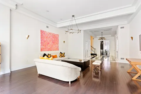 a living room with furniture and a chandelier