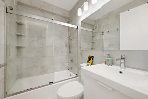 a bathroom with a sink toilet and shower