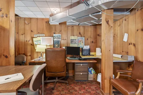 a view of a kitchen with a sink and a table and chairs