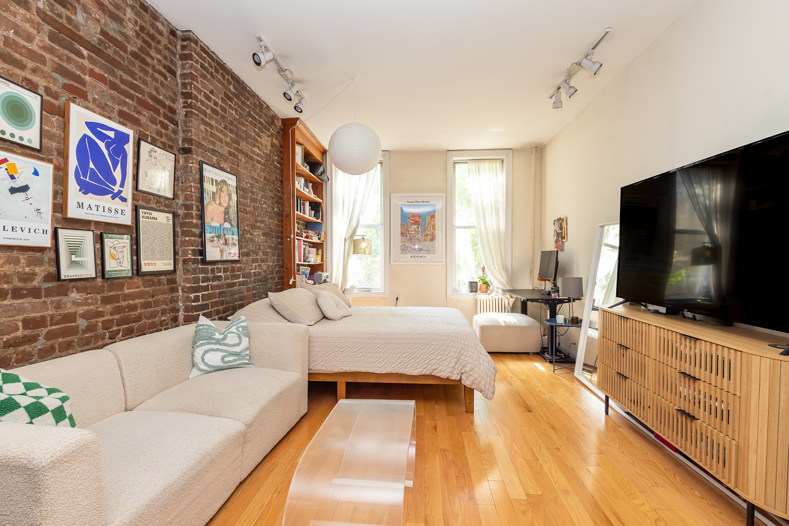 147 Sullivan Street, Unit 2A Manhattan, NY 10012 - Photo 1 of 8 a living room with furniture and a flat screen tv