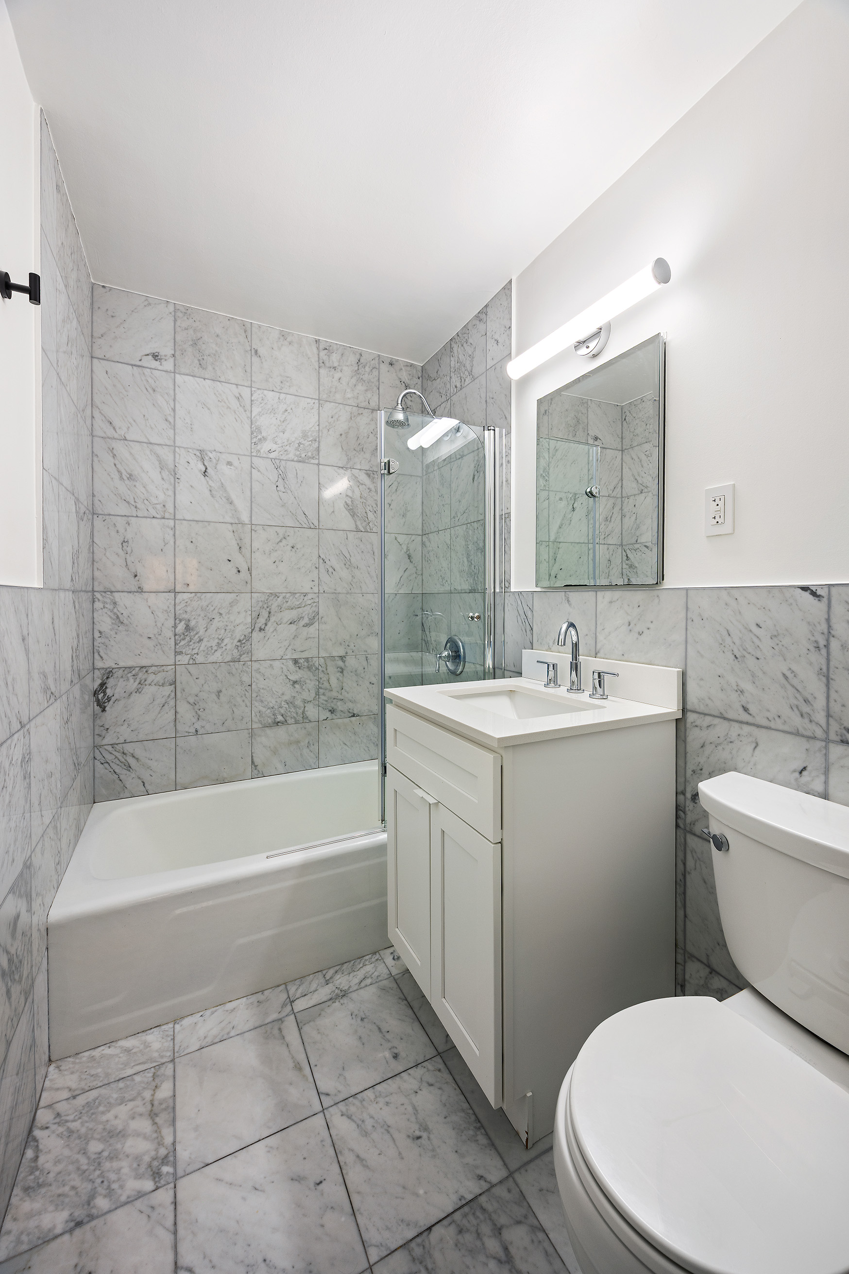 123 East 75th Street, Unit 6B Manhattan, NY 10021 - Photo 11 of 13 a bathroom with a sink a toilet and bathtub