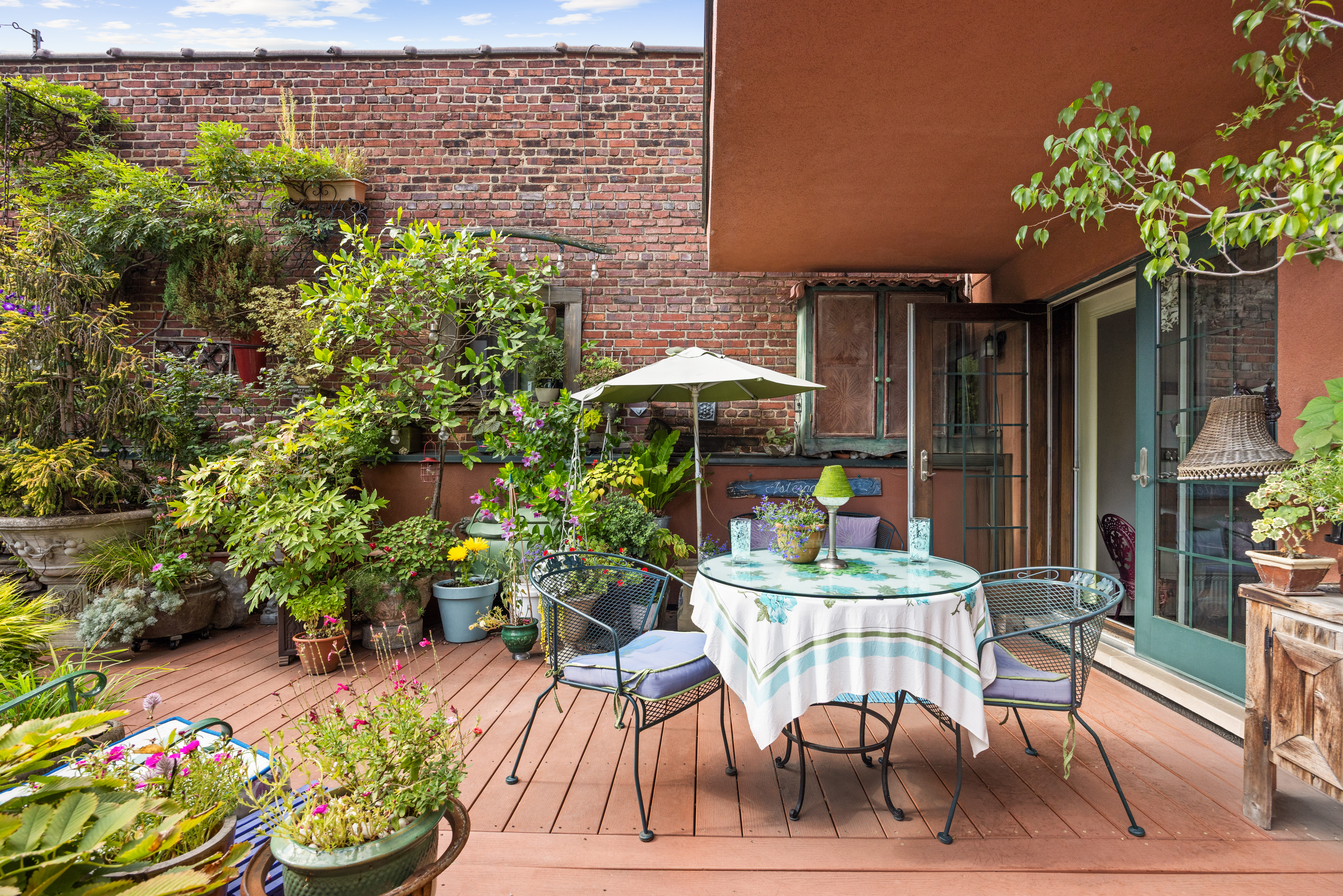 607 Manhattan Avenue, Unit 2 Brooklyn, NY 11222 - Photo 4 of 14 a patio with a table and chairs and potted plants