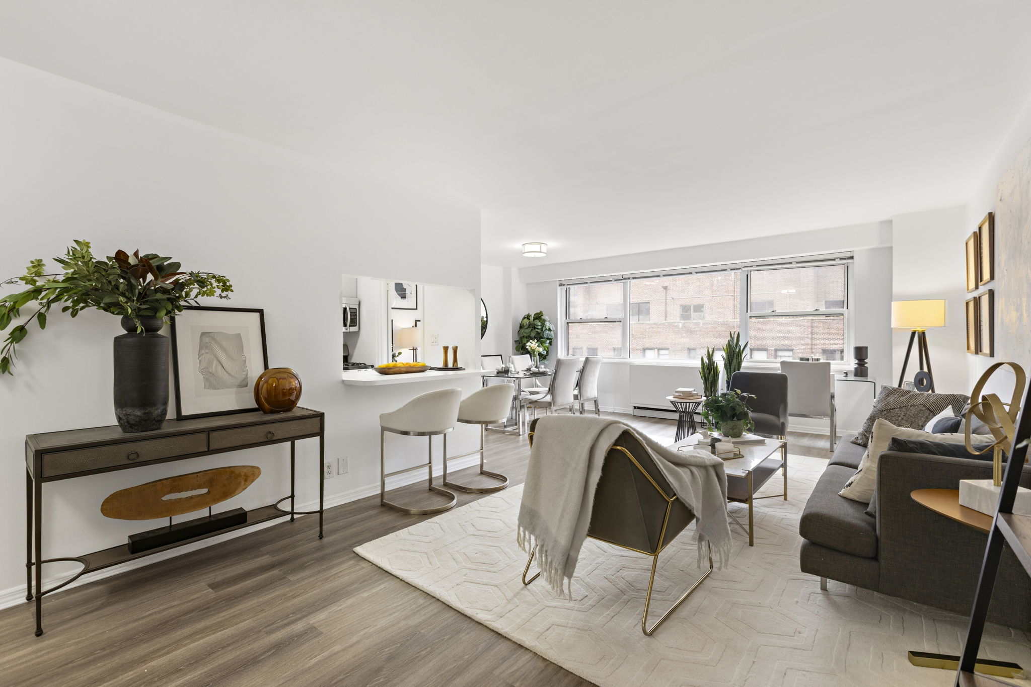 400 East 54th Street, Unit 18E Manhattan, NY 10022 - Photo 3 of 22 a living room with furniture a rug and a floor to ceiling window