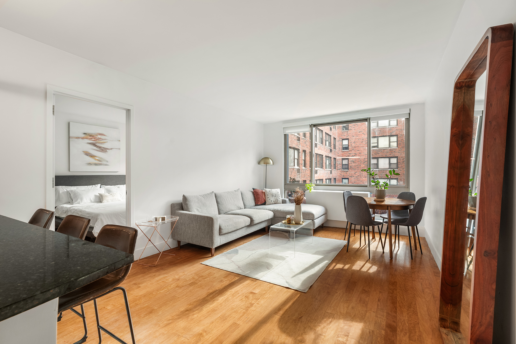 242 East 25th Street, Unit 3A Manhattan, NY 10010 - Photo 3 of 9 a living room with furniture and a large window