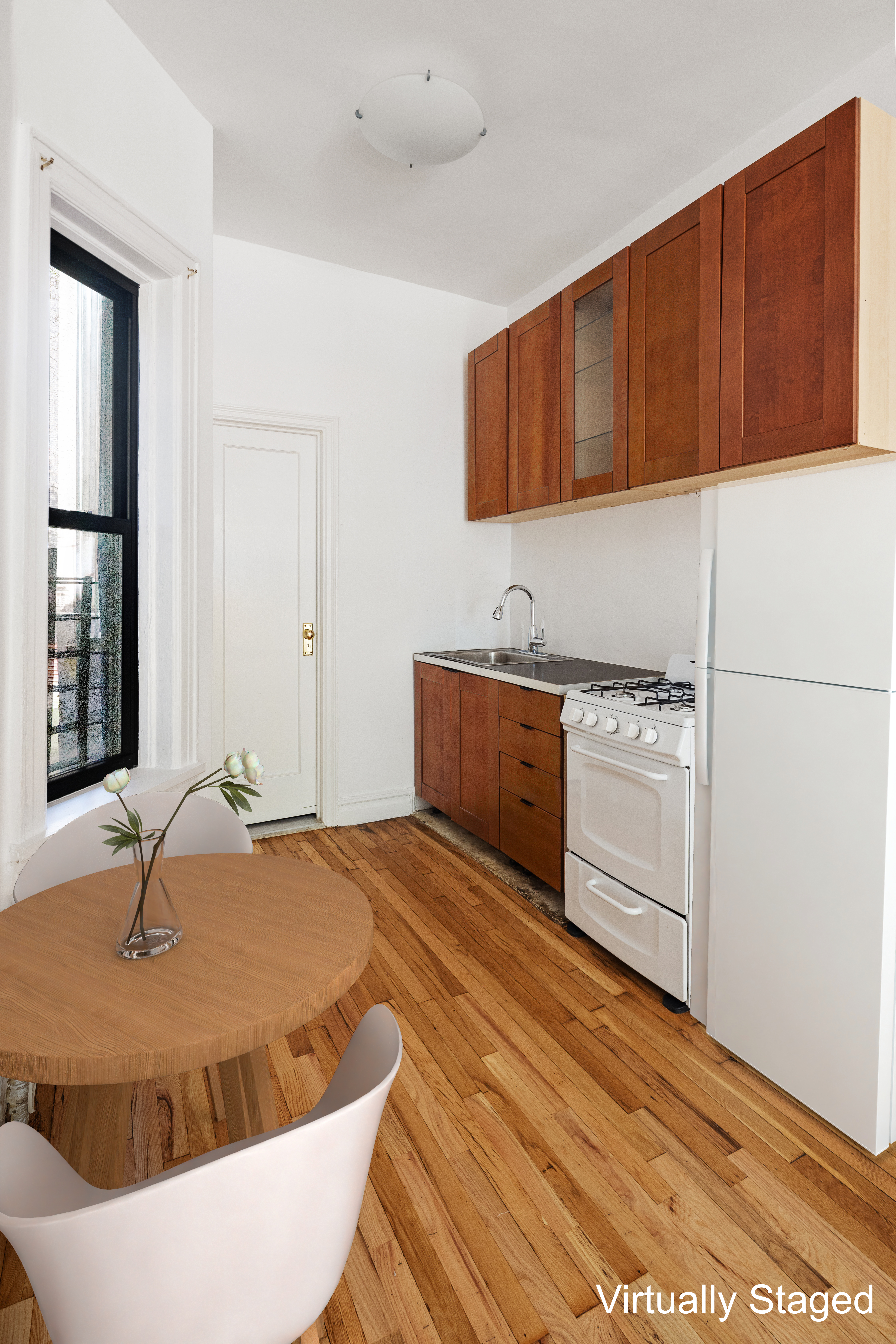 107 West 106th Street, Unit D Manhattan, NY 10025 - Photo 8 of 12 a kitchen with granite countertop a sink a stove and cabinets