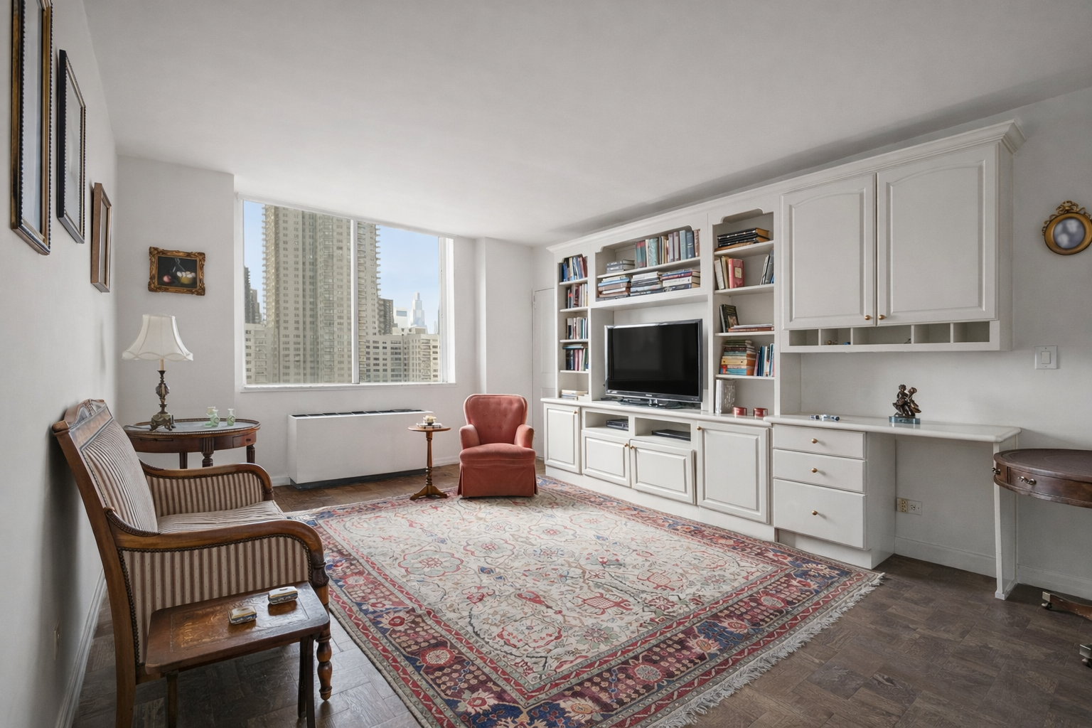 515 East 79th Street, Unit 15A Manhattan, NY 10075 - Photo 10 of 26 a living room with furniture a flat screen tv and a refrigerator