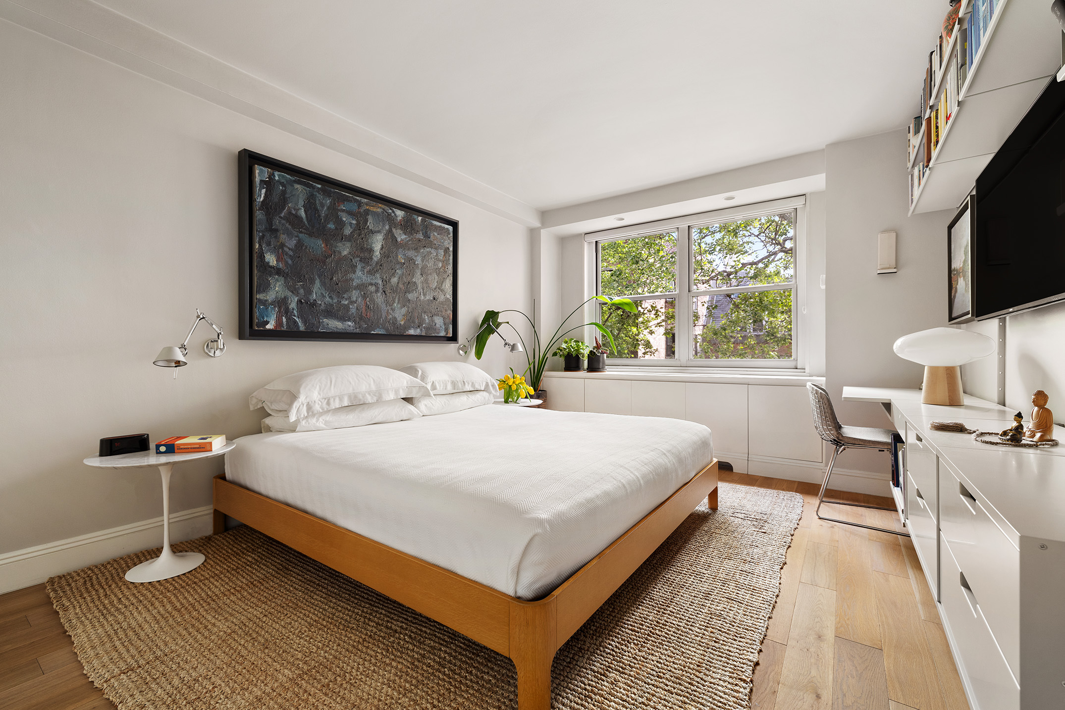 360 West 22nd Street, Unit 5M Manhattan, NY 10011 - Photo 8 of 16 a bedroom with a bed and a flat screen tv