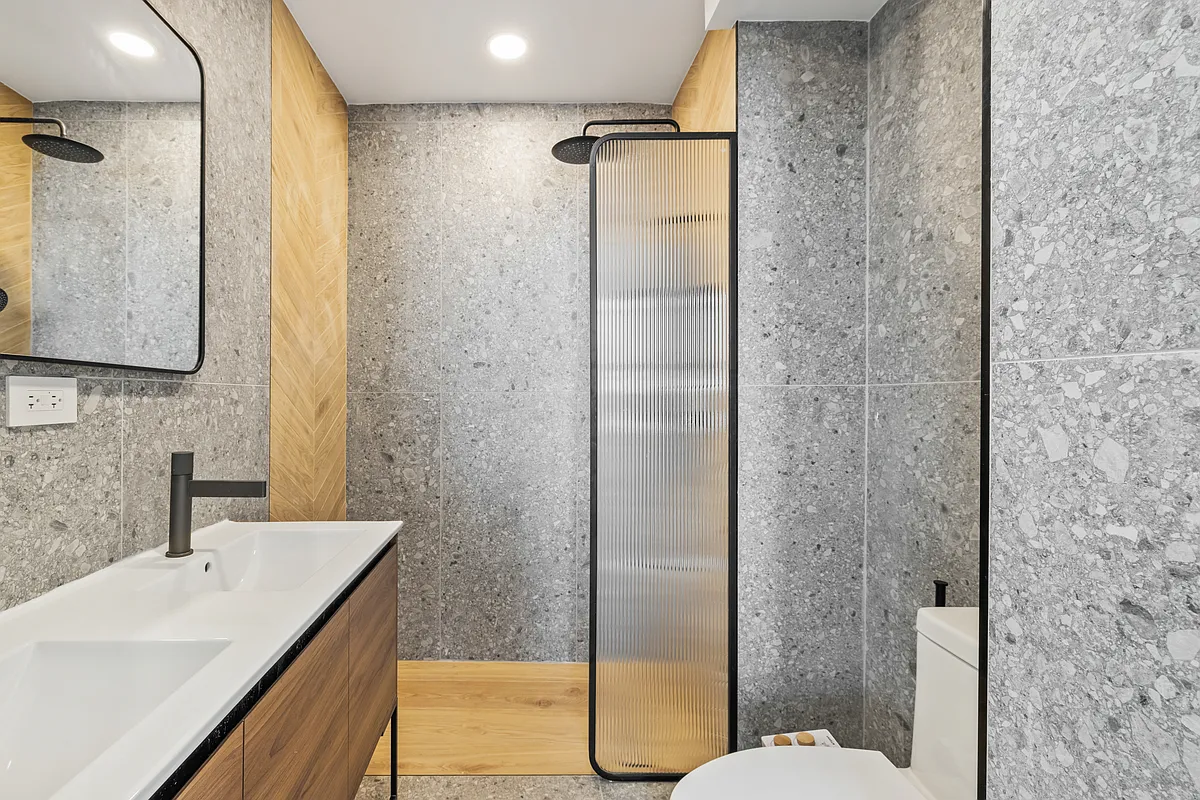 76 Meserole Avenue, Unit 2A Brooklyn, NY 11222 - Photo 10 of 10 a bathroom with a granite countertop sink toilet and shower