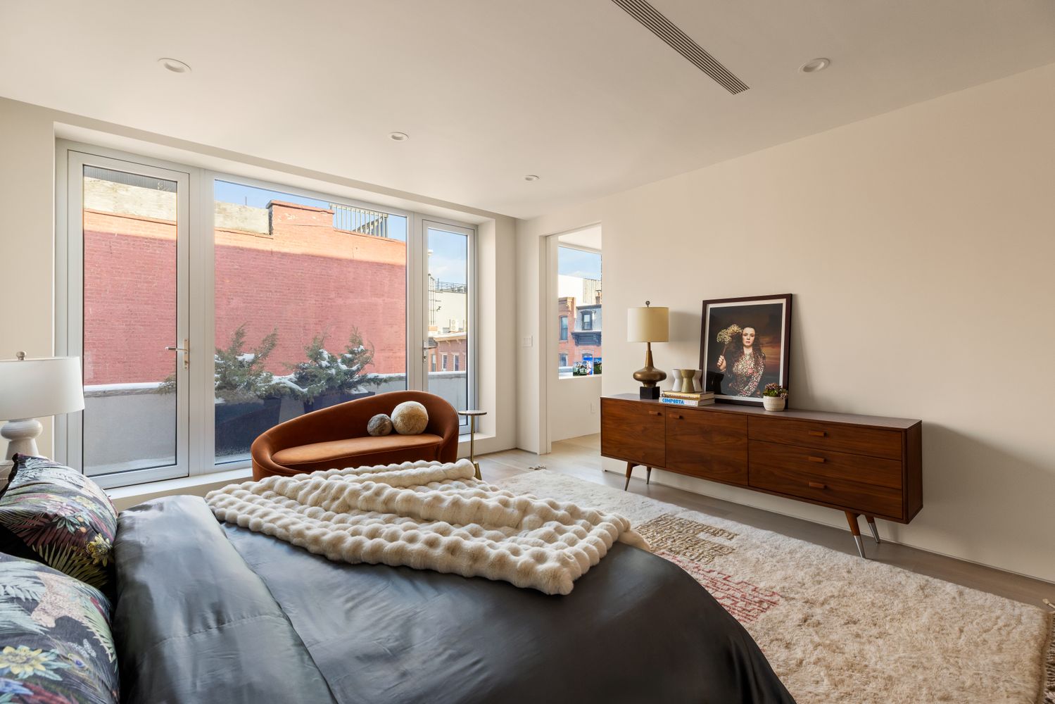 a bedroom with furniture and a window