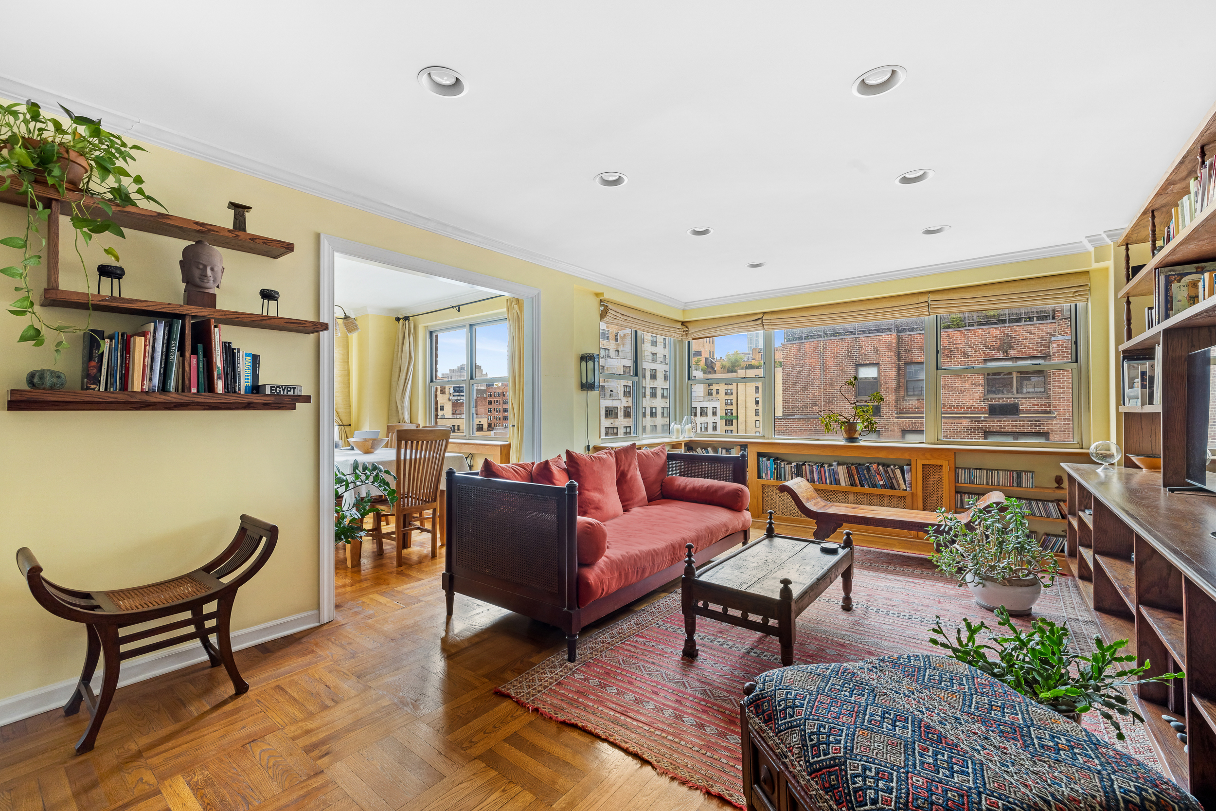 a living room with furniture and a potted plant