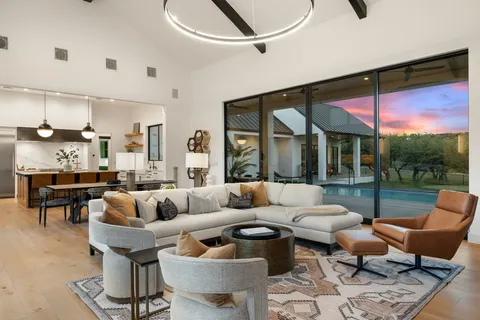 a living room with furniture a rug and a large window