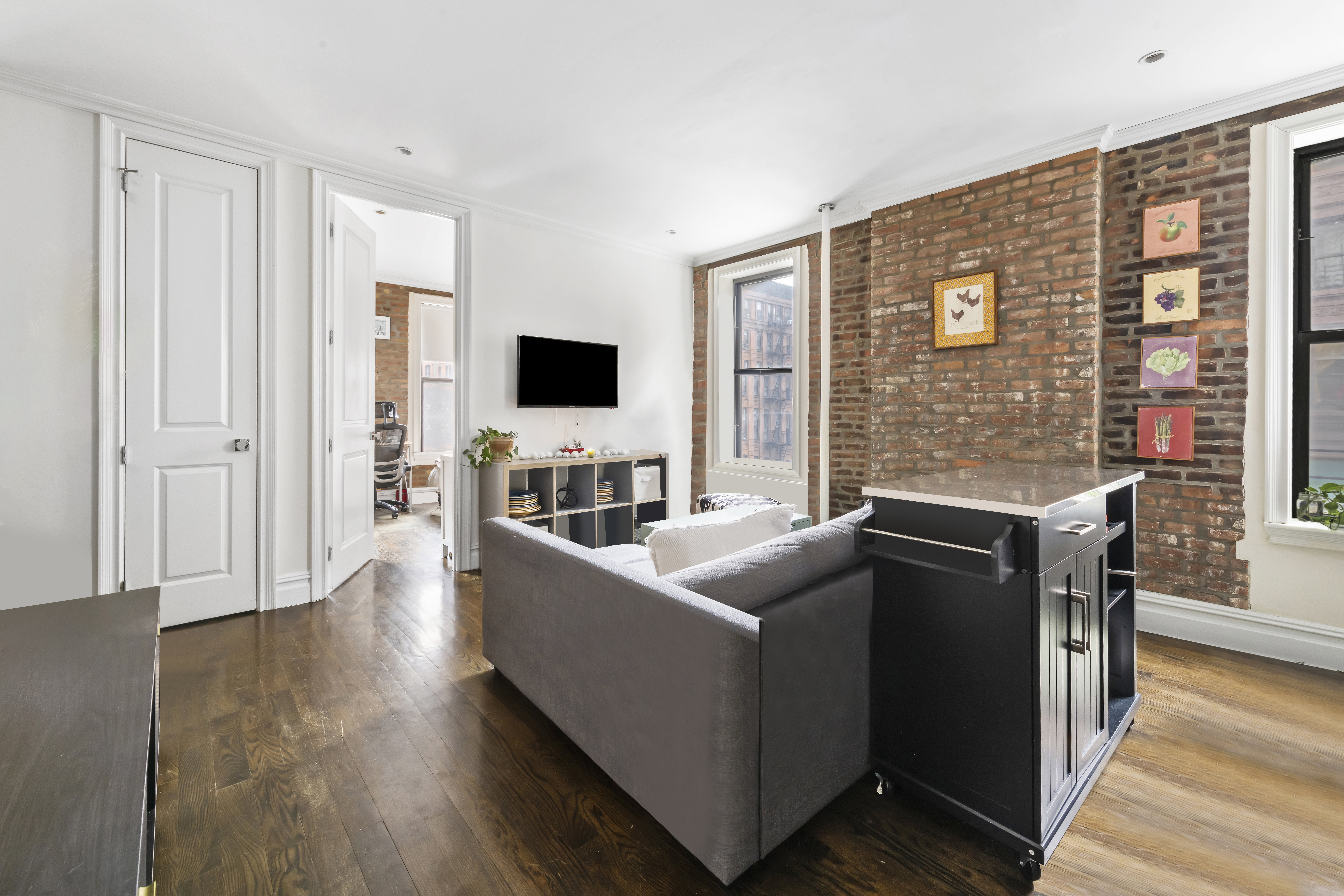 170 West 83rd Street, Unit 2W Manhattan, NY 10024 - Photo 2 of 10 a living room with furniture and a flat screen tv