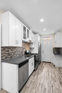 a kitchen with stainless steel appliances granite countertop a stove and a sink
