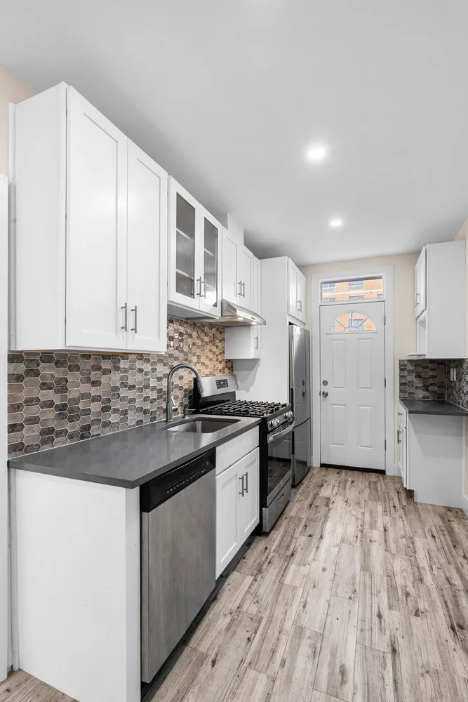 a kitchen with stainless steel appliances granite countertop a stove and a sink