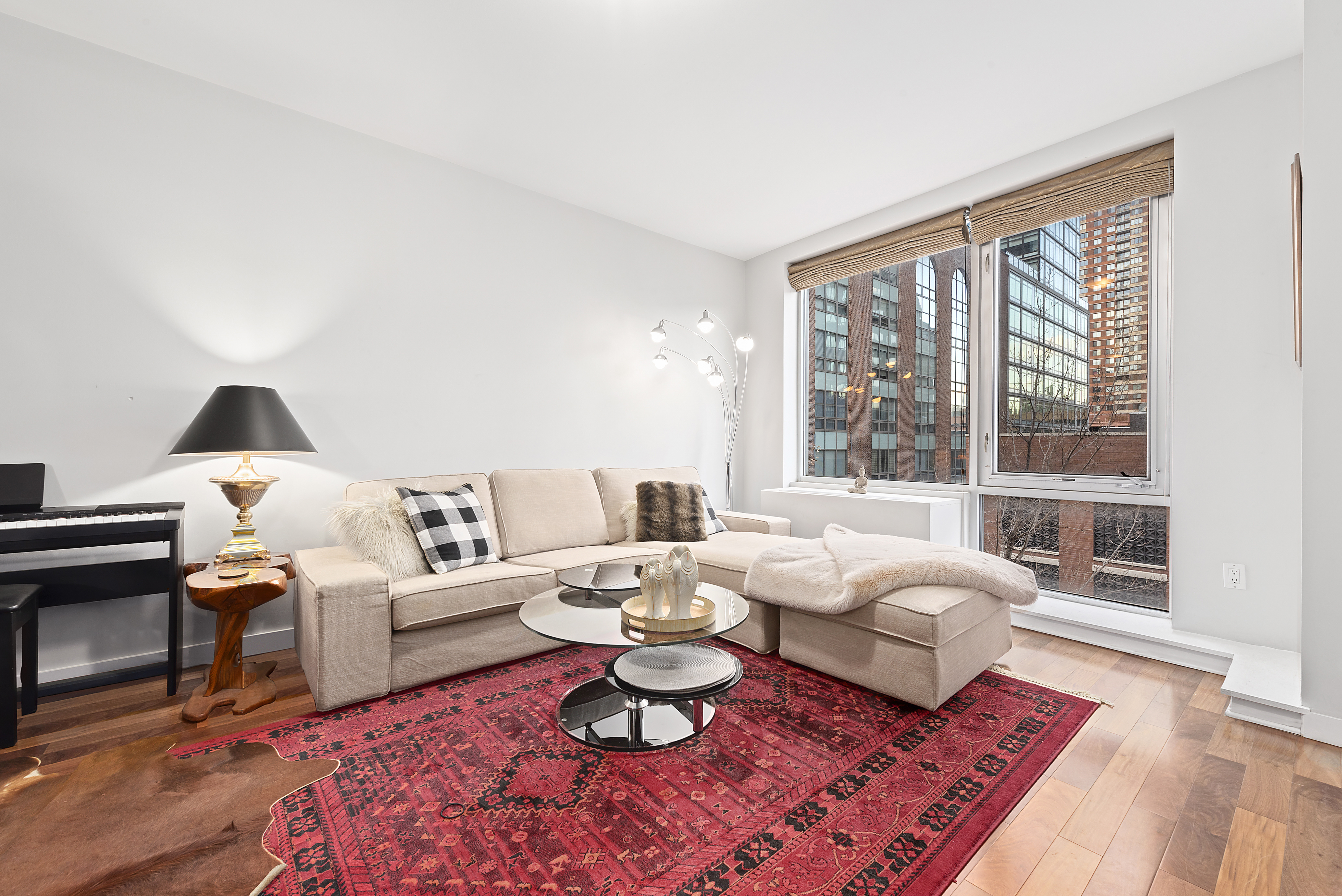 2-40 51st Avenue, Unit 2N Queens, NY 11101 - Photo 5 of 12 a living room with furniture and a large window