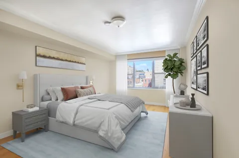 a bedroom with a bed and a potted plant