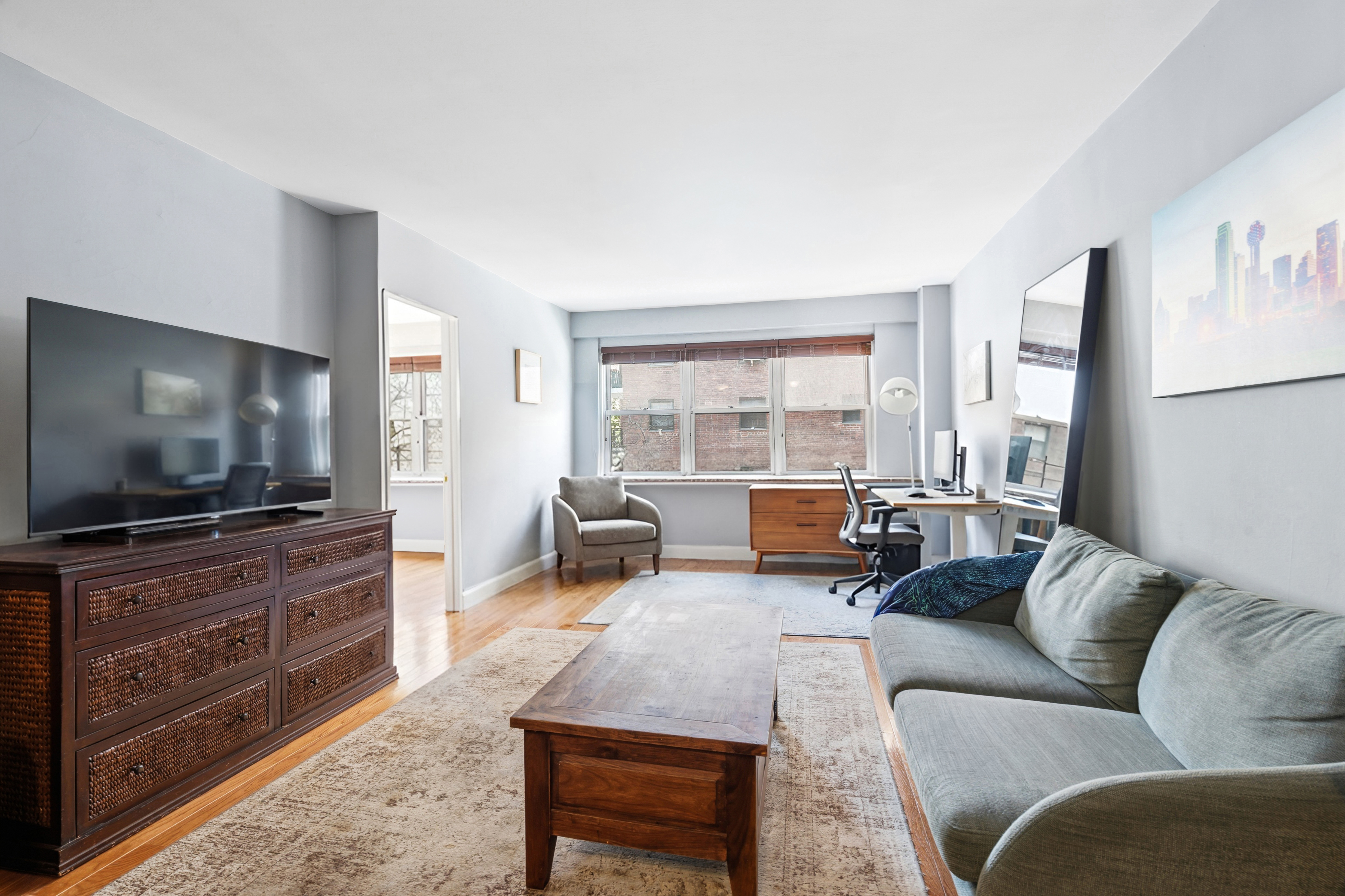 166 East 35th Street, Unit 5C Manhattan, NY 10016 - Photo 2 of 16 a living room with furniture and a flat screen tv