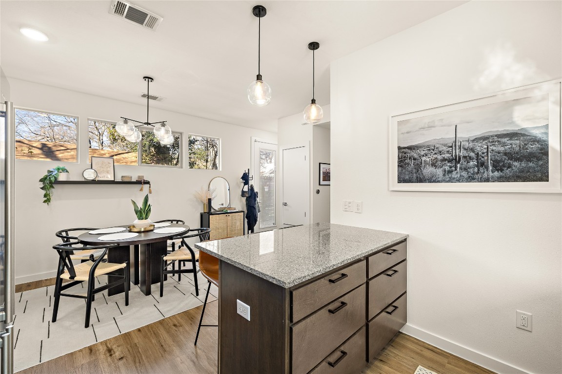 1402 Singleton Avenue, Unit B Austin, TX 78702 - Photo 9 of 26 a view of kitchen island with furniture and refrigerator