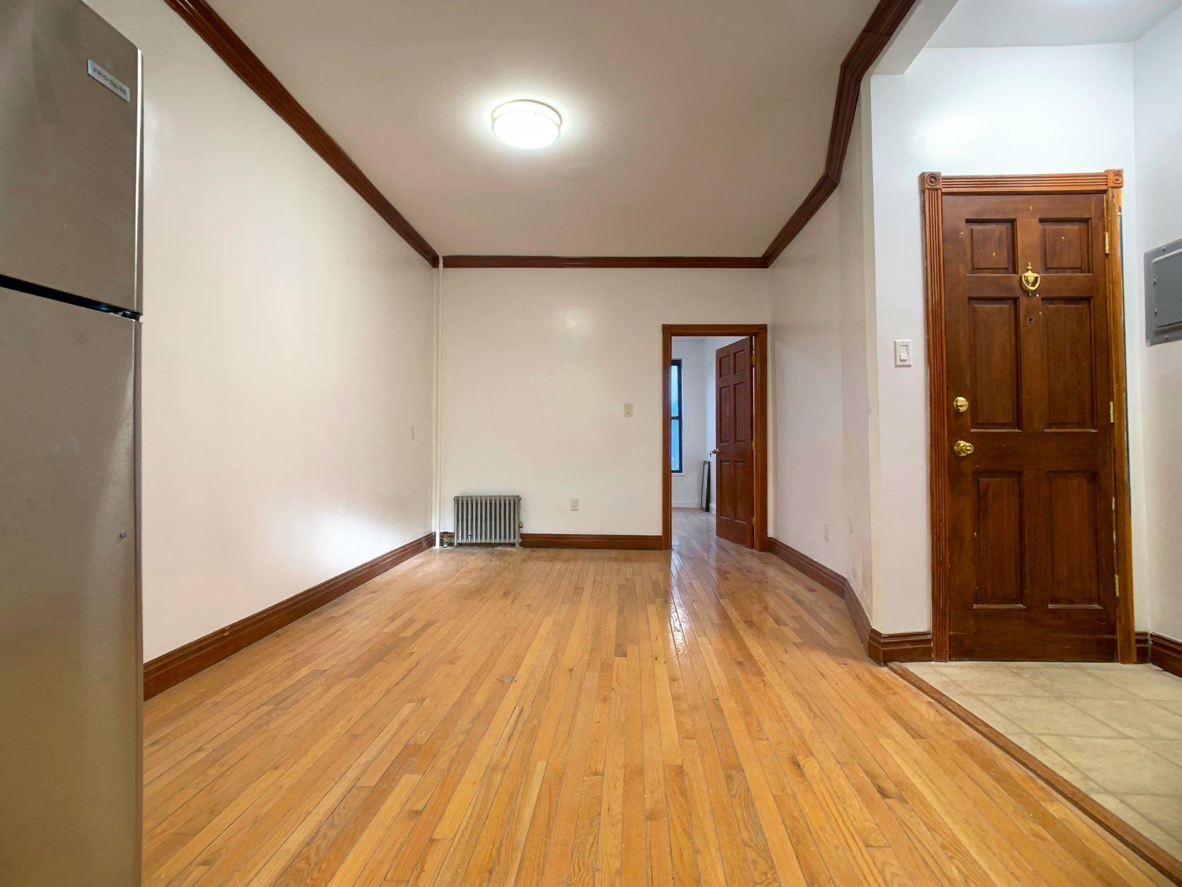 630 President Street, Unit 1 Brooklyn, NY 11215 - Photo 2 of 11 a view of an empty room with wooden floor and a window
