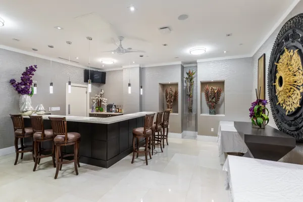 a view of a dining room with furniture and chandelier