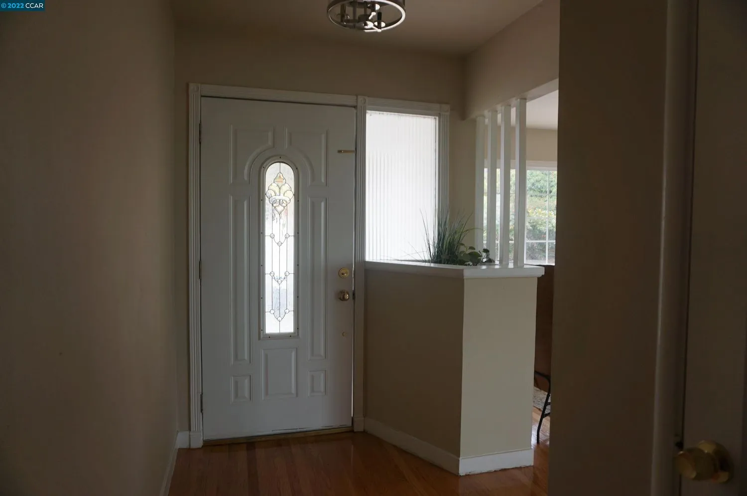 a view of an entryway door with a mirror