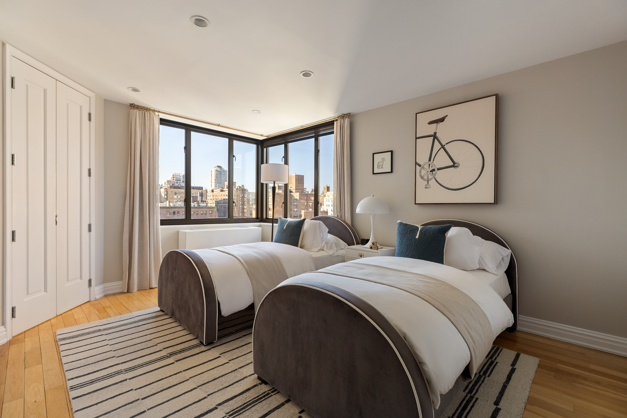 1438 3rd Avenue, Unit 15B Manhattan, NY 10028 - Photo 8 of 21 a bedroom with two beds and wooden floor