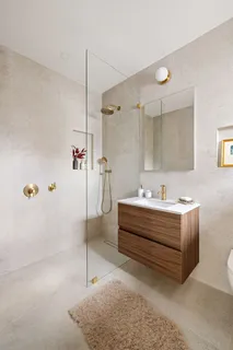 a bathroom with a tub sink and mirror