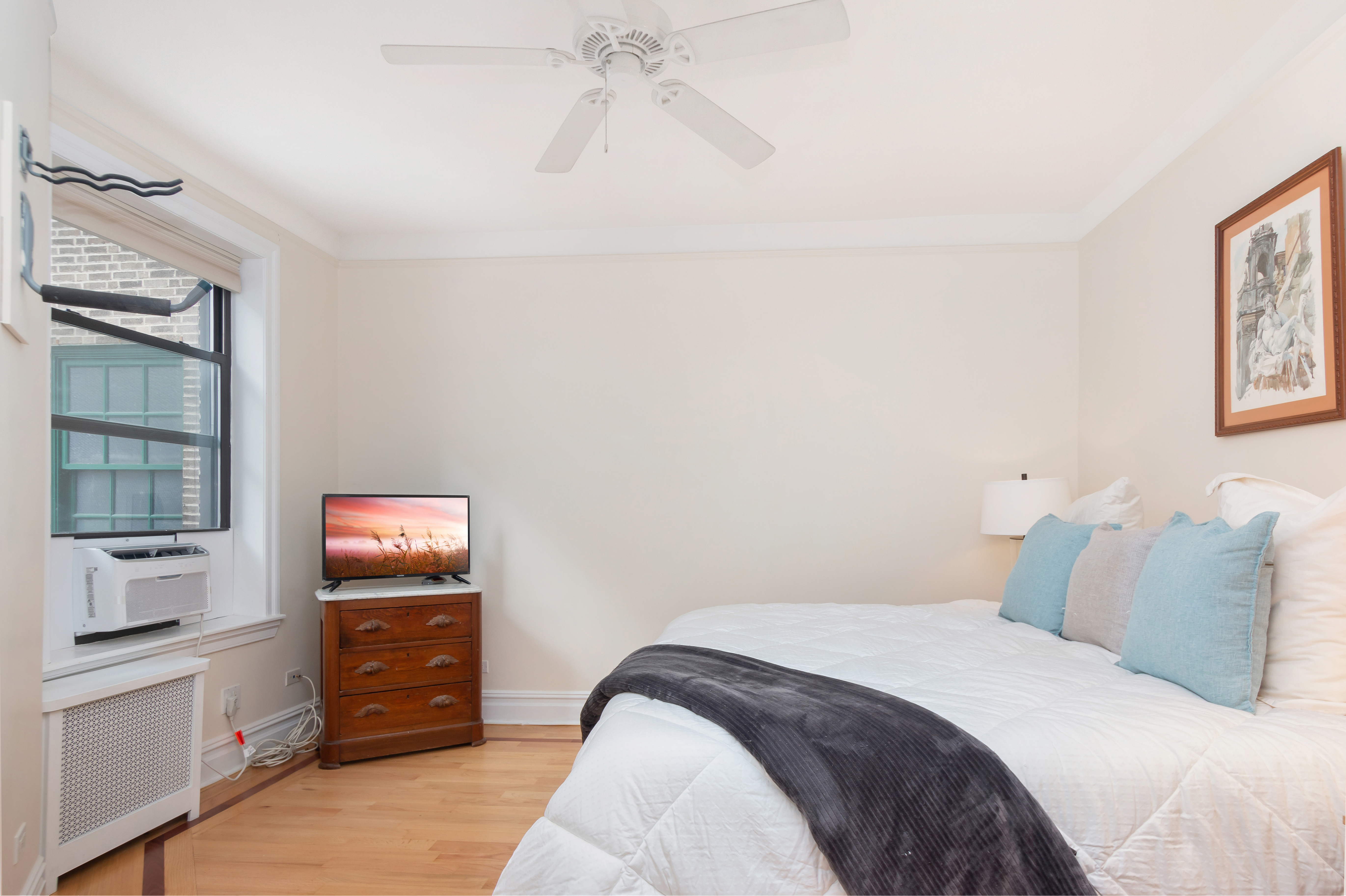 801 Riverside Drive, Unit 4F Manhattan, NY 10032 - Photo 10 of 13 a bedroom with a bed and a tv