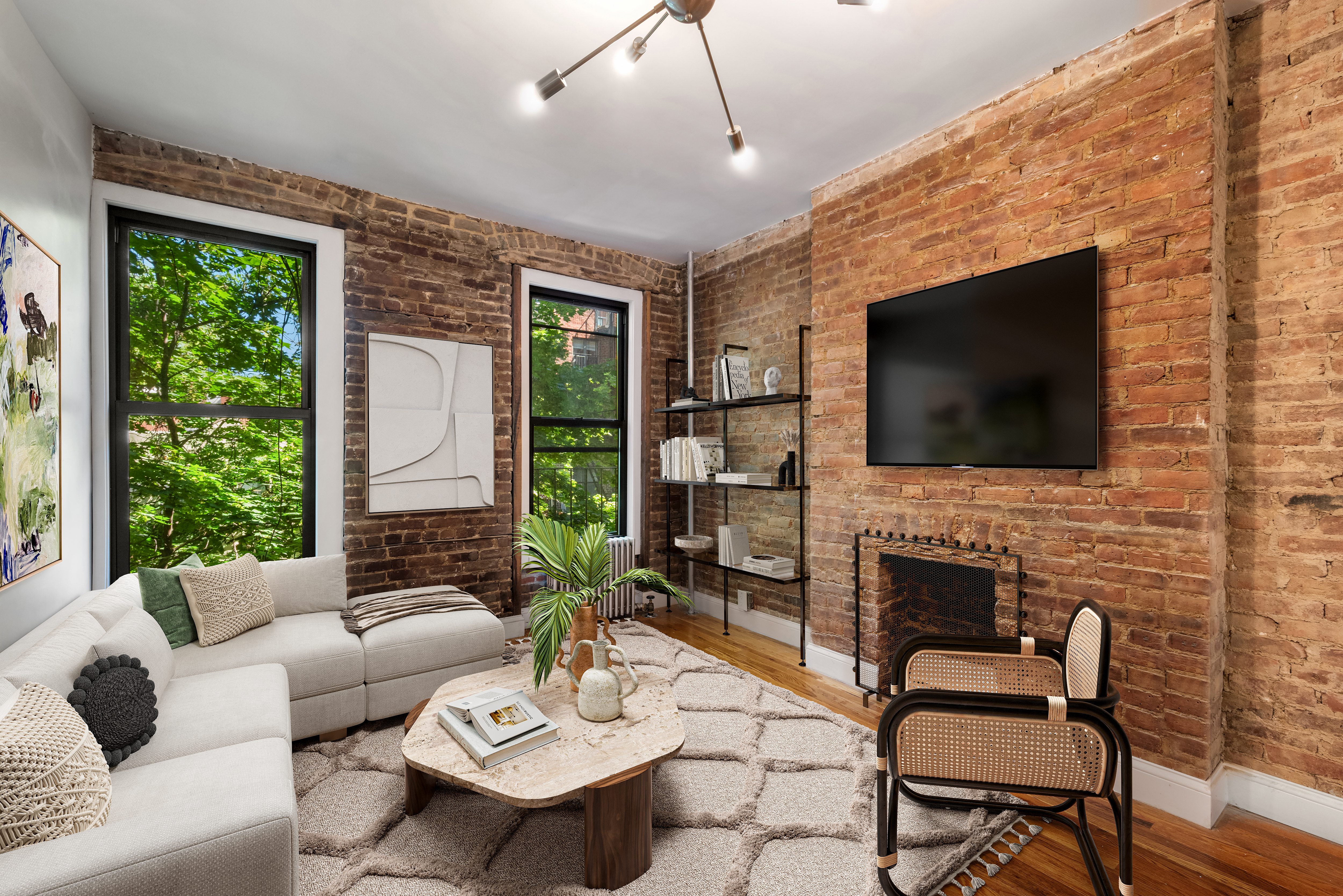 317 East 73rd Street, Unit 4RE Manhattan, NY 10021 - Photo 1 of 8 a living room with furniture fireplace and a flat screen tv