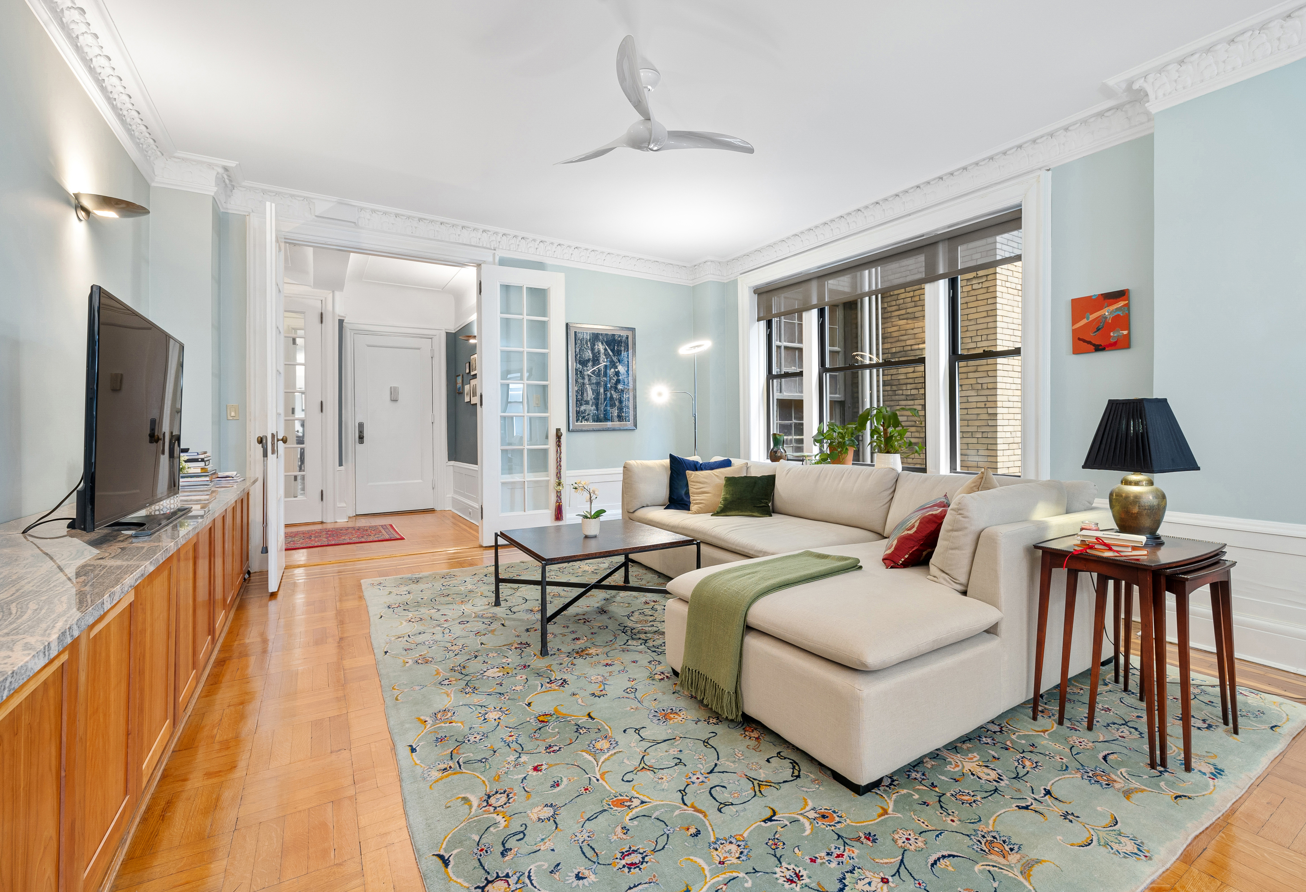 200 West 54th Street, Unit 9G Manhattan, NY 10019 - Photo 6 of 17 a living room with furniture and a flat screen tv