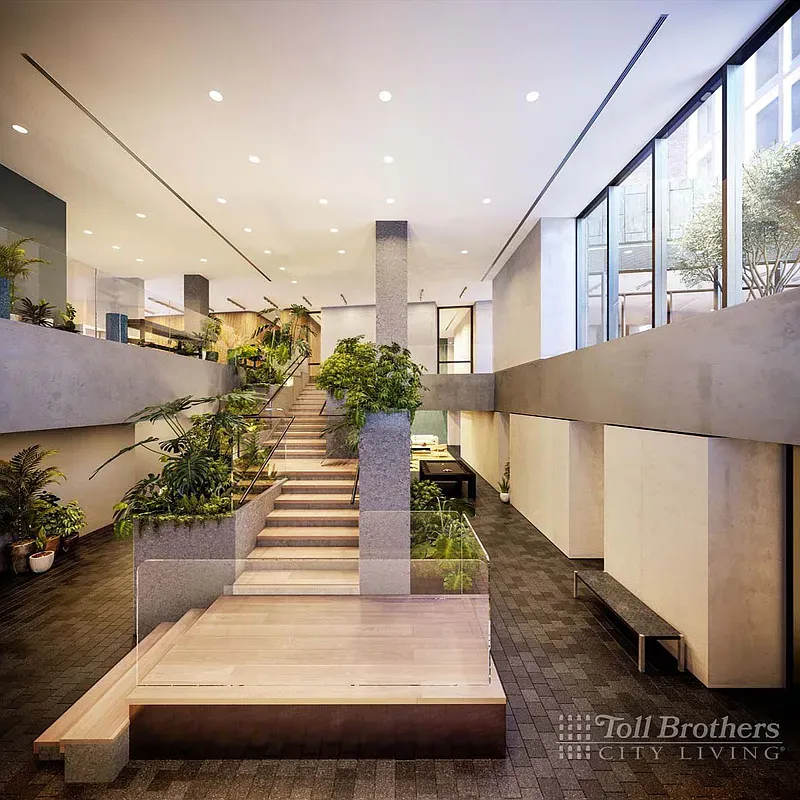 a lobby with furniture and a potted plant