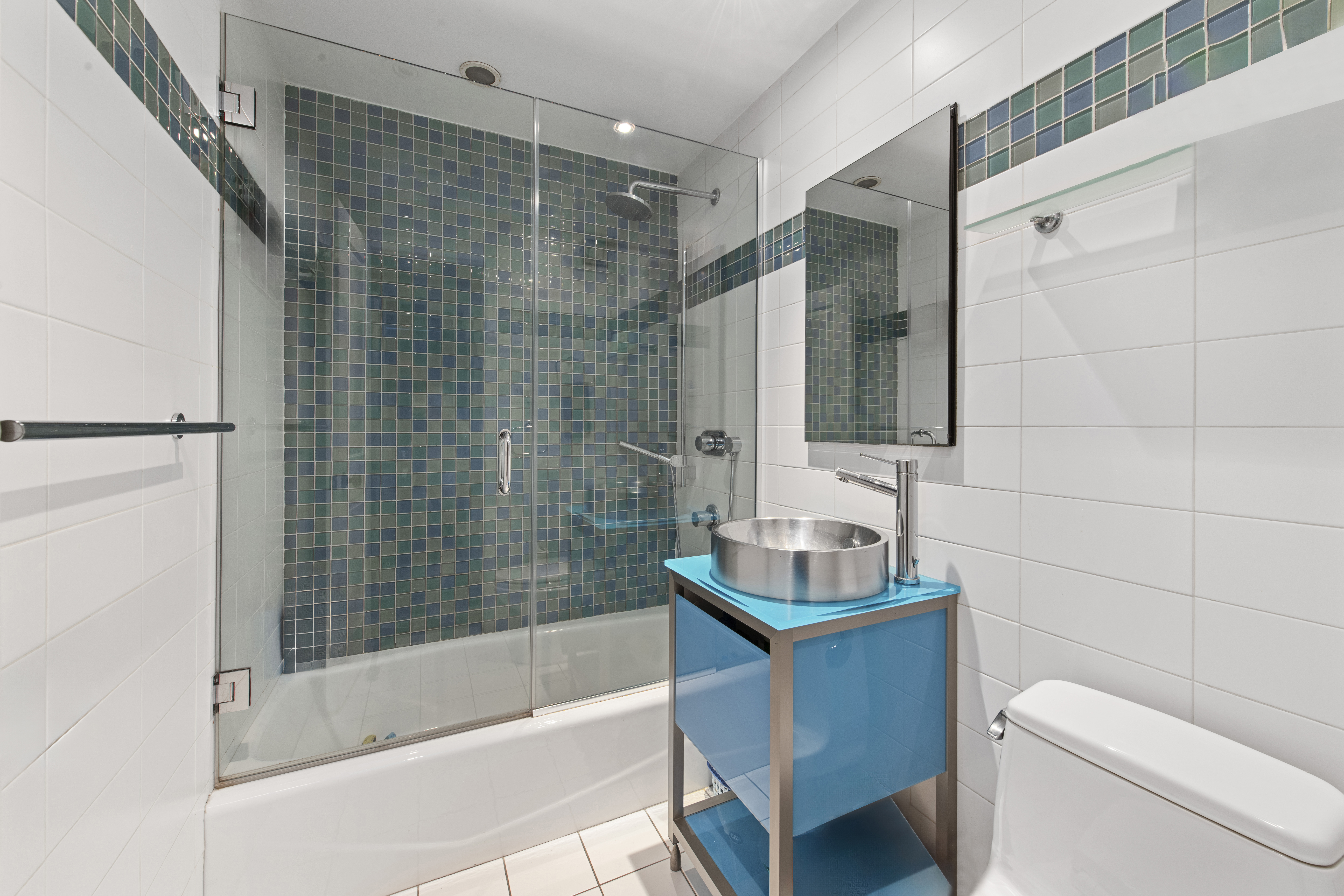 400 East 56th Street, Unit 3D Manhattan, NY 10022 - Photo 16 of 24 a bathroom with a sink toilet and shower